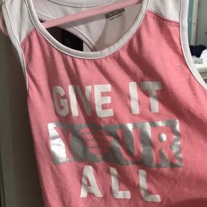 Pink, sleeveless, athletic shirt. Size: Medium (10-12)